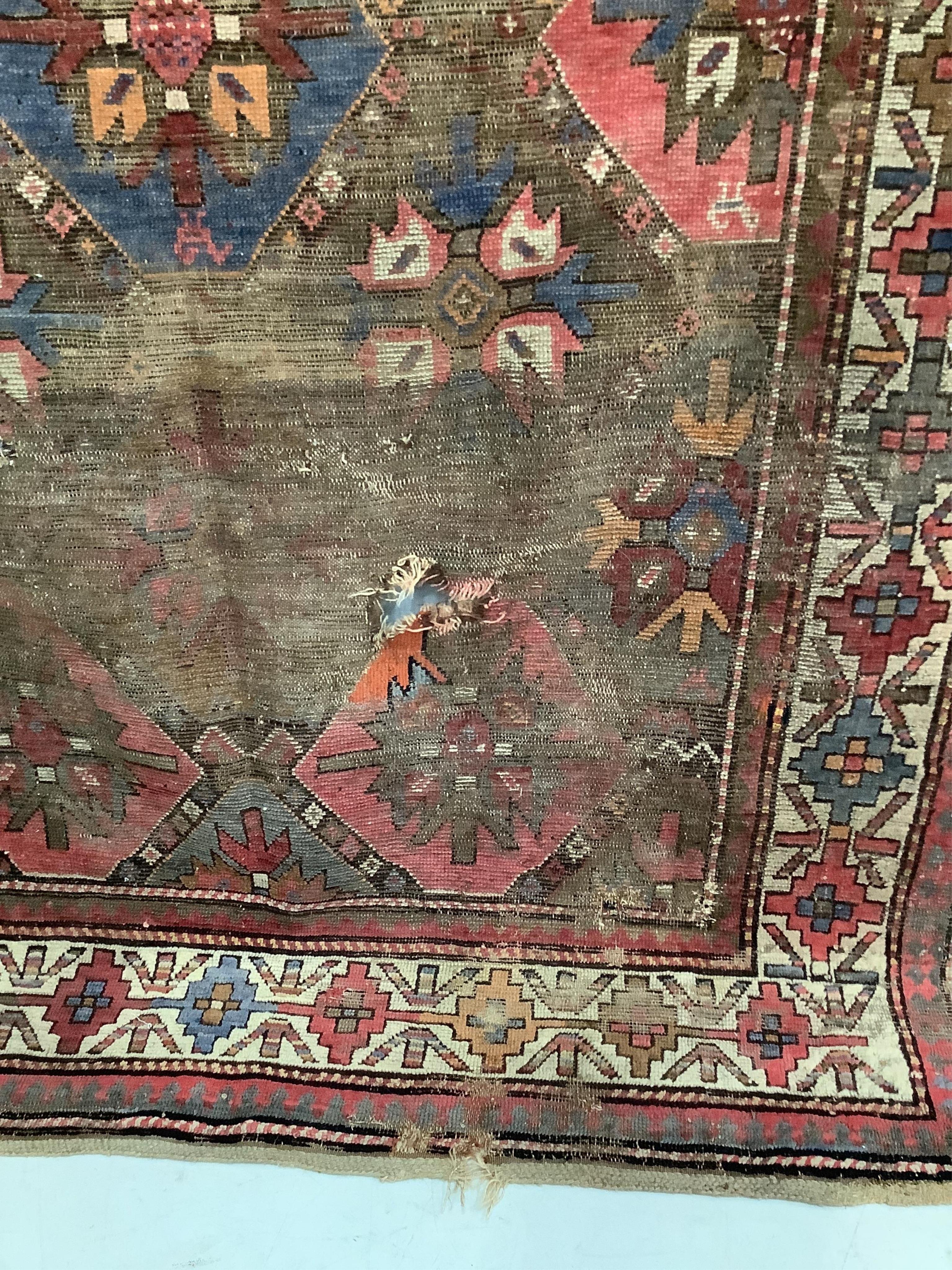 An antique Caucasian geometric rug, 250 x 140cm, together with a Belouch prayer rug, 130 x 78cm. Condition - poor